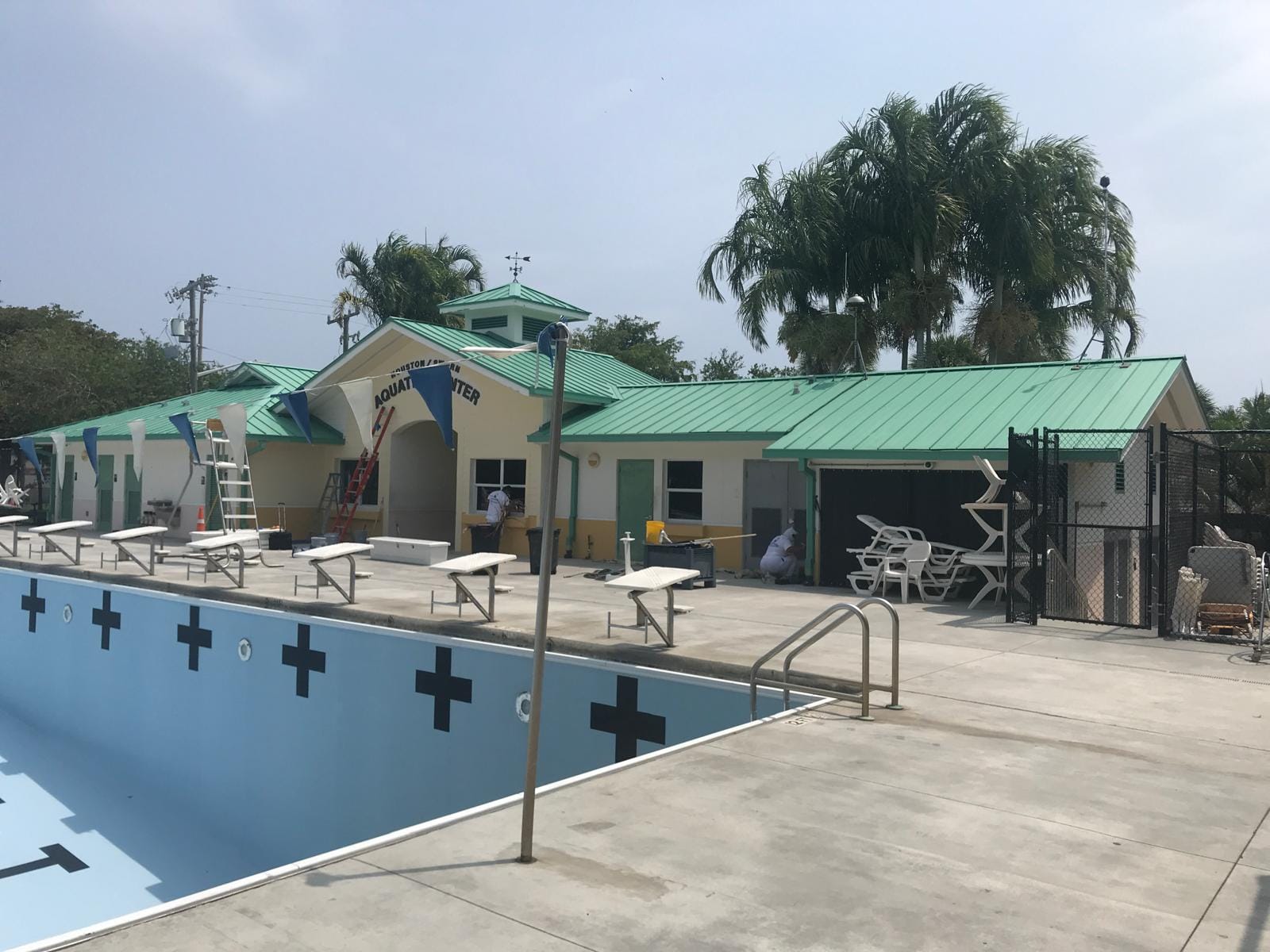 Pompano Beach Aquatic Center pool and building exterior during finishing work