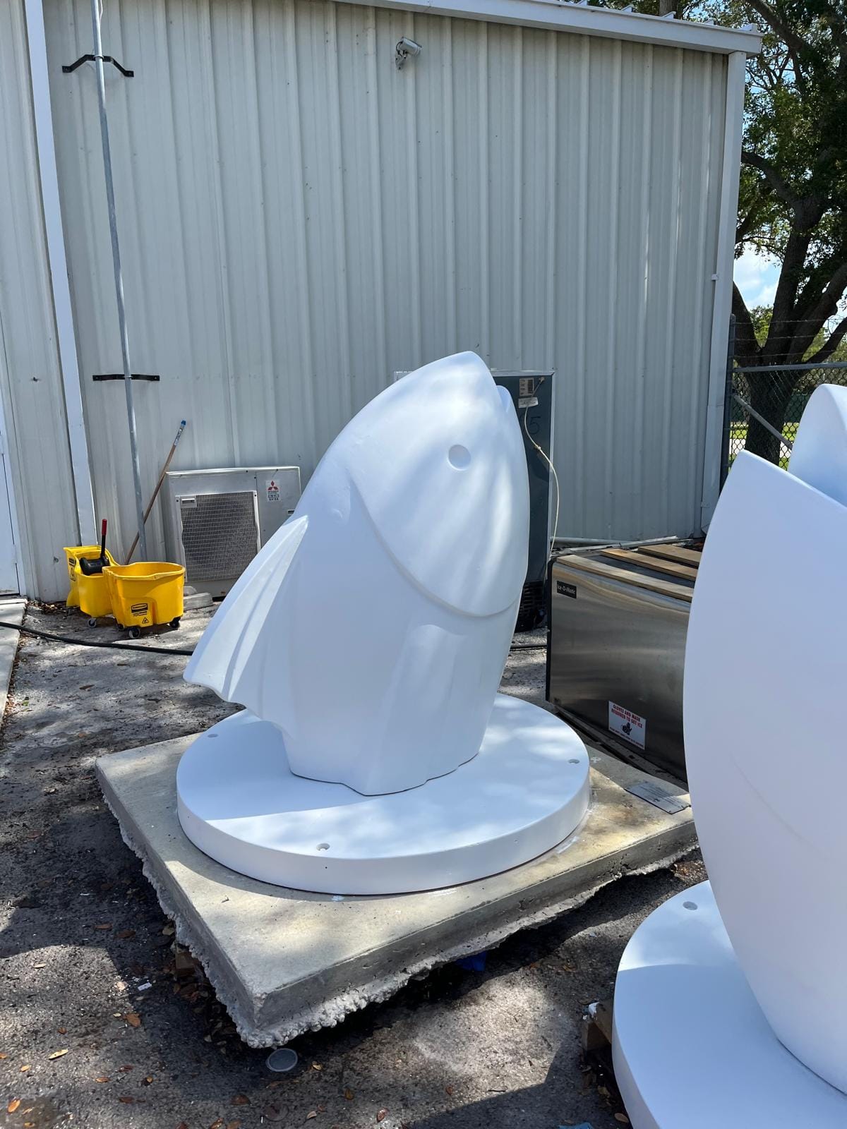 Public art fish sculpture after surface prep and priming — finished white
